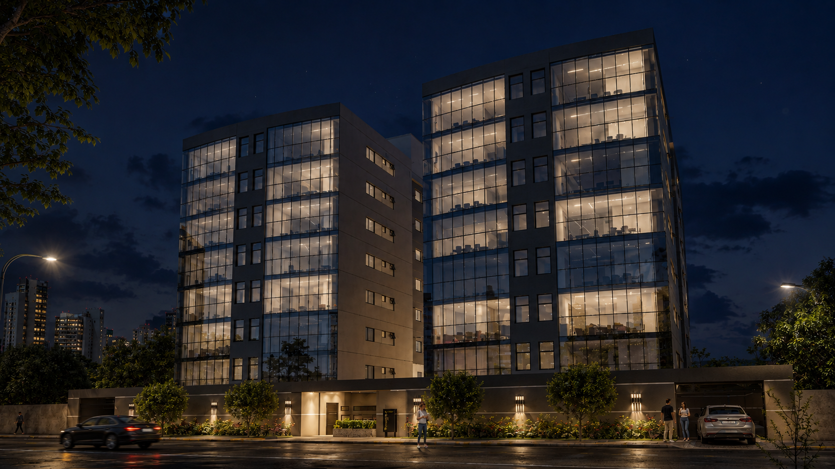 Fachada iluminada do RAMGAD Residence ao anoitecer